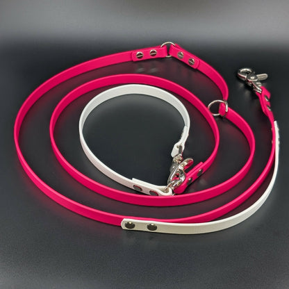 pink and white biothane hands free dog leash with adjustable waist attachment and traffic handle