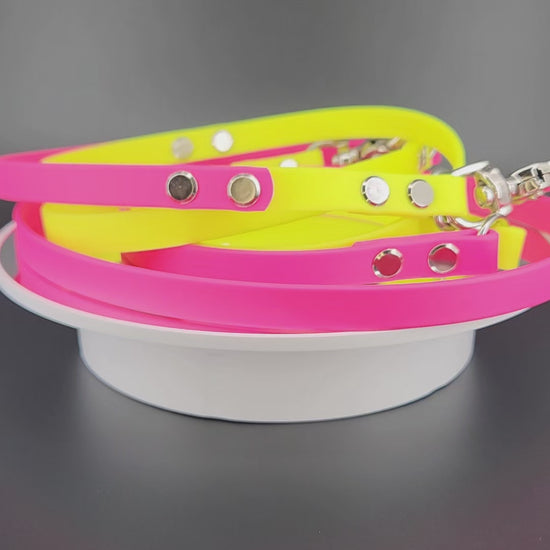 1/2 inch wide pink and yellow biothane hands free dog leash with built in traffic handle and silver trigger snaps