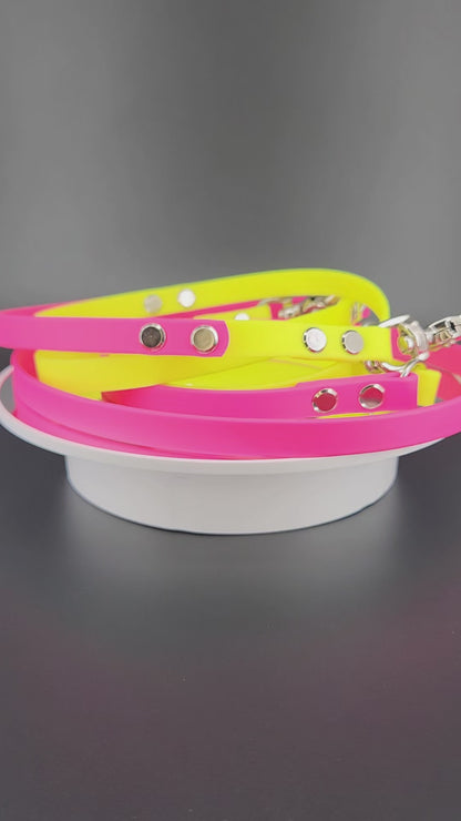 1/2 inch wide pink and yellow biothane hands free dog leash with built in traffic handle and silver trigger snaps