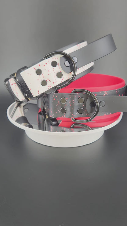 2 inch wide layered biothane dog collars, each with a tactical handle, splatter paint, custom glitter text, and quick release cobra buckle