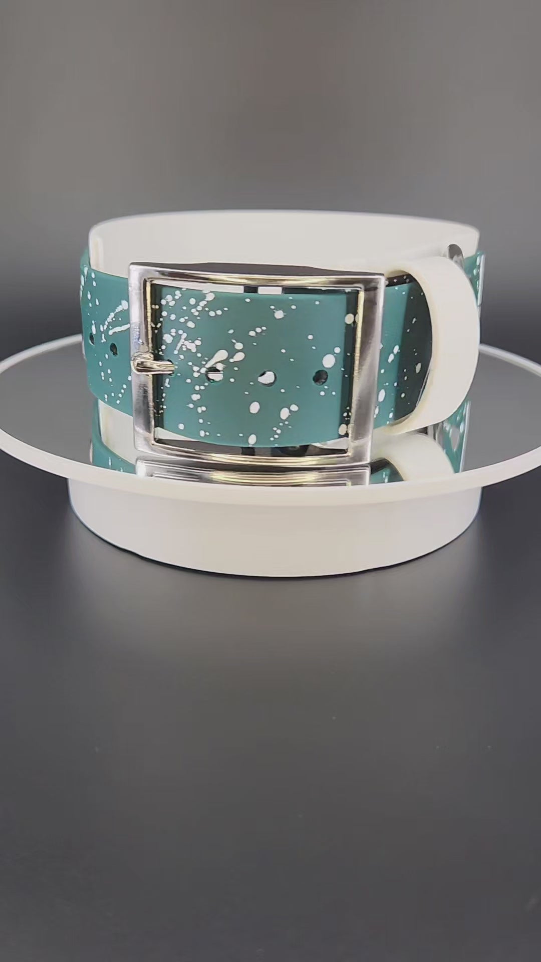 2 inch wide white and dark green layered biothane dog collar with glitter pet your own fucking dog text, white splatter paint, and silver hardware
