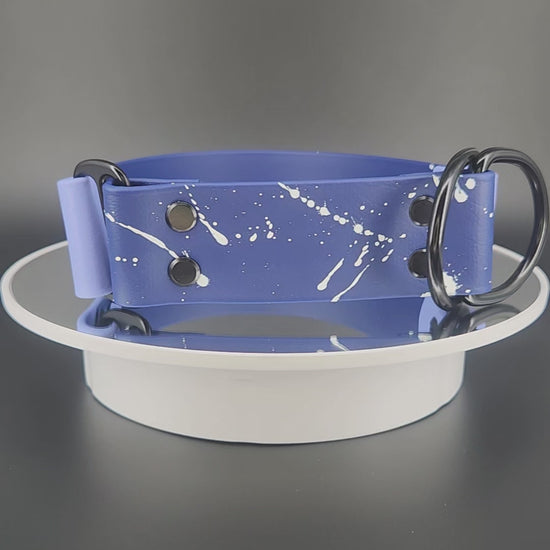 1.5 inch wide navy blue and periwinkle blue biothane limited slip dog collar with splatter paint and glitter feral af text