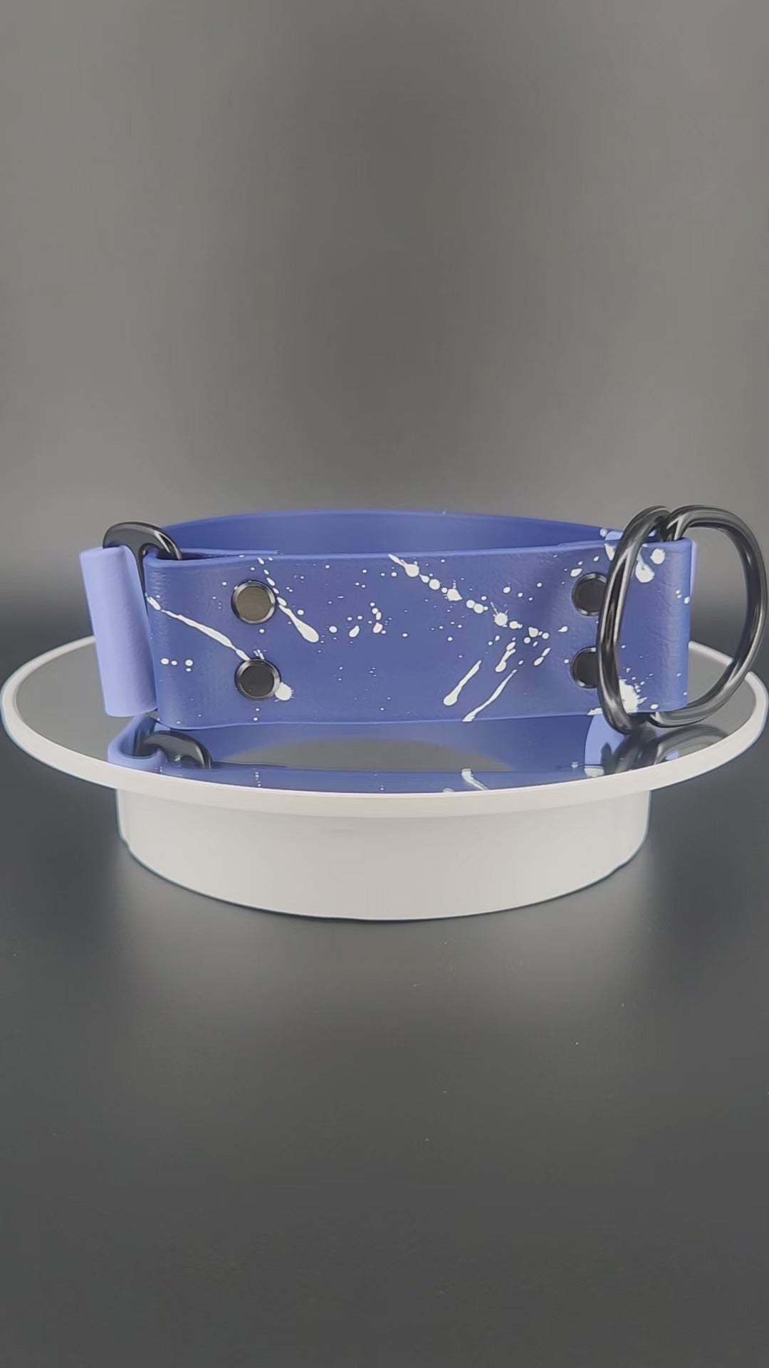1.5 inch wide navy blue and periwinkle blue biothane limited slip dog collar with splatter paint and glitter feral af text