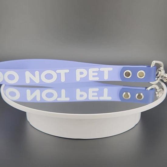 periwinkle and navy blue biothane traffic handle with silver floating o ring and trigger snap with white glitter DO NOT PET text