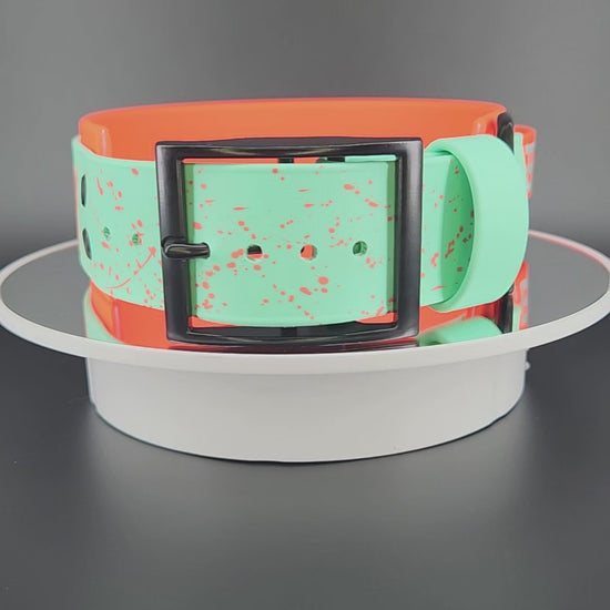 2 inch wide orange and sage green layered biothane dog collar with tactical handle, custom glitter text, and splatter paint