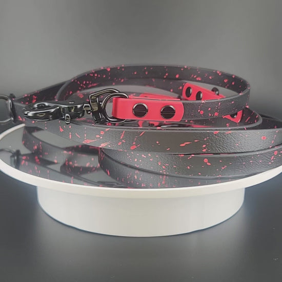 black and red biothane hands free dog leash with black hardware and red splatter paint