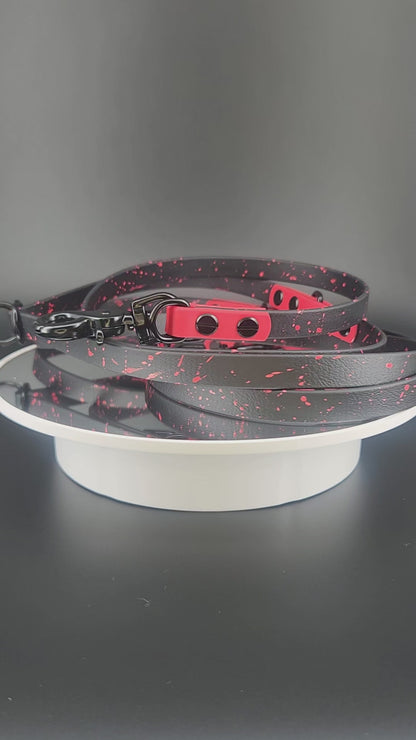 black and red biothane hands free dog leash with black hardware and red splatter paint