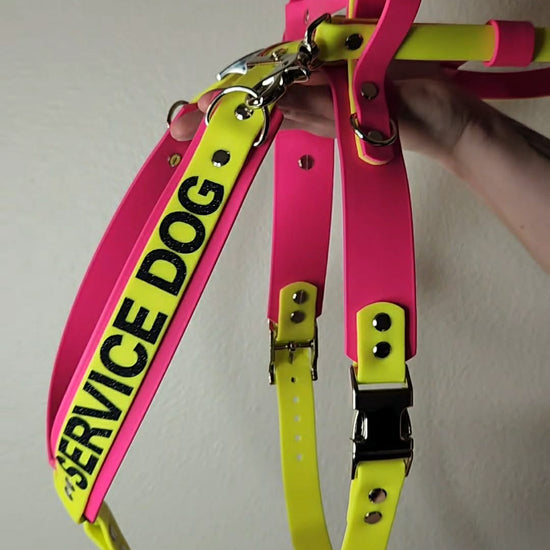 pink and yellow biothane y front service dog harness with built-in counterbalance handle and detachable pull strap
