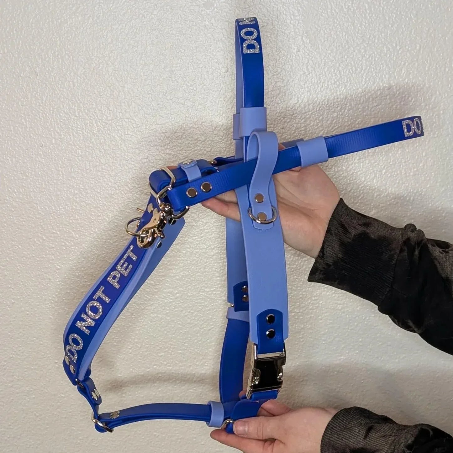 Two hands holding a Ready to Ship - Periwinkle and Royal Blue Biothane Y-Front Service Dog Mobility Harness with Counterbalance Handle and Pull Strap - Outer Space Dog Gear