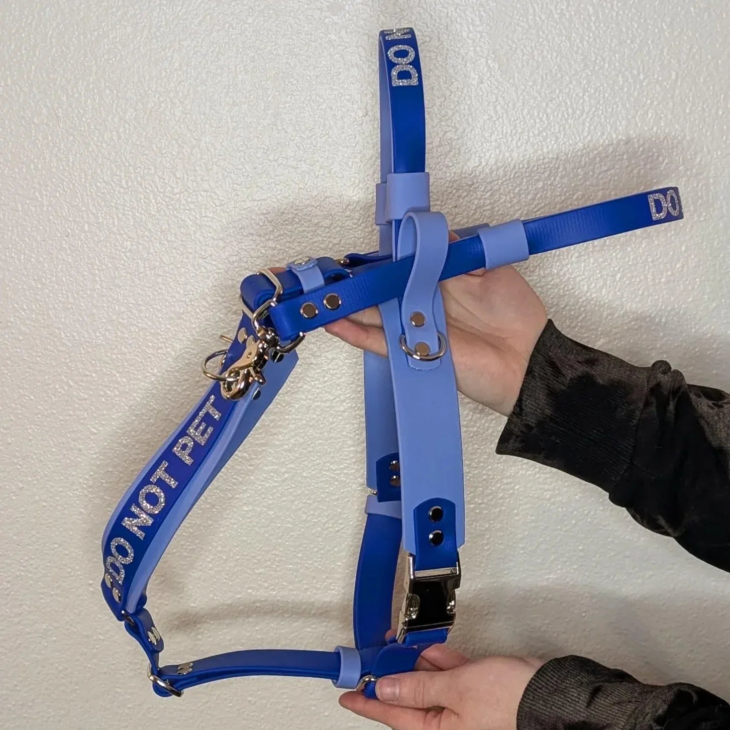 Two hands holding a Ready to Ship - Periwinkle and Royal Blue Biothane Y-Front Service Dog Mobility Harness with Counterbalance Handle and Pull Strap - Outer Space Dog Gear