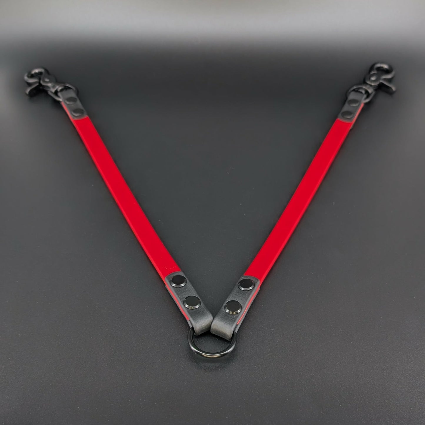 red and black biothane leash coupler for walking two dogs