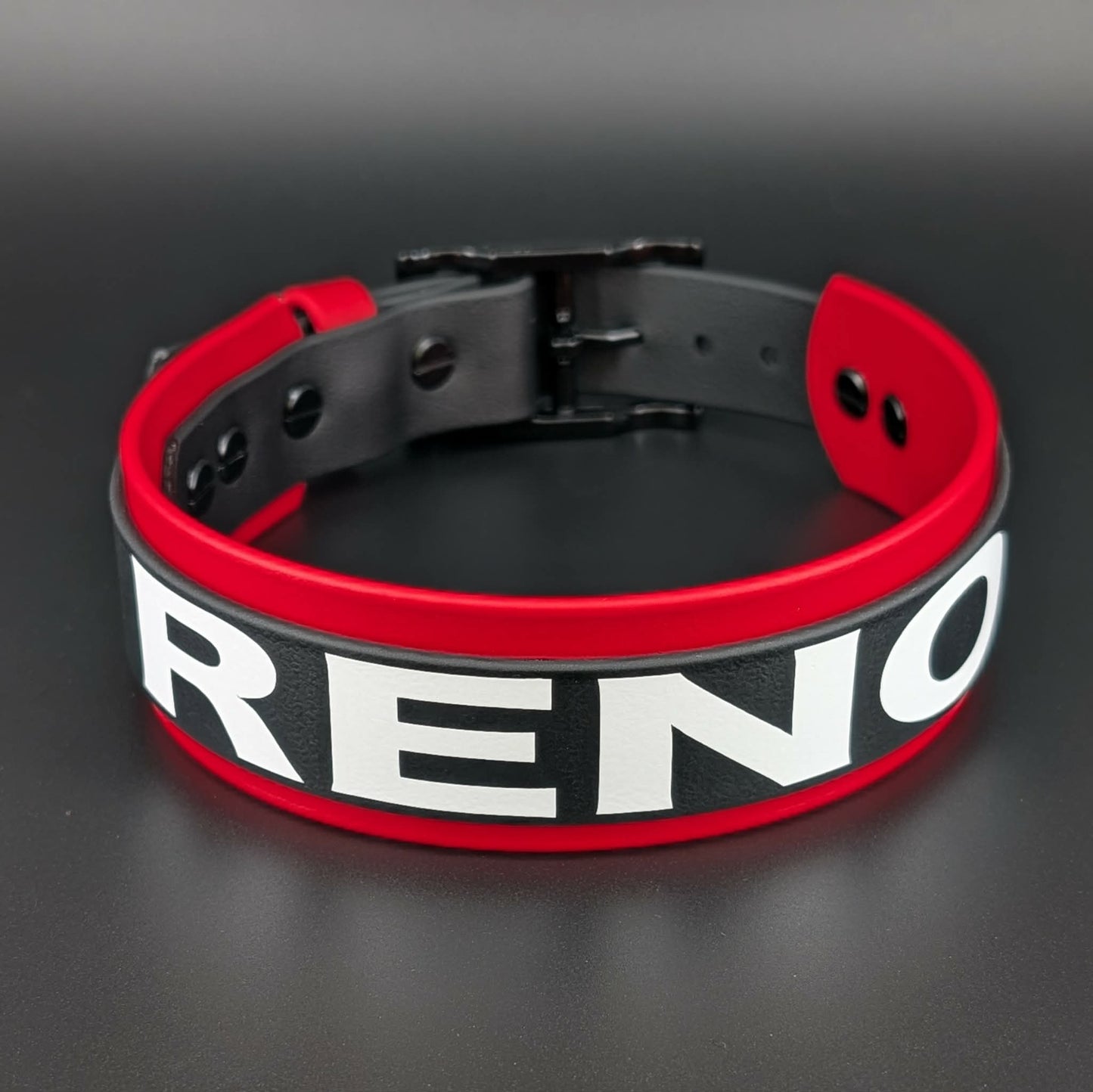 red and black layered biothane dog collar with custom text reading reno