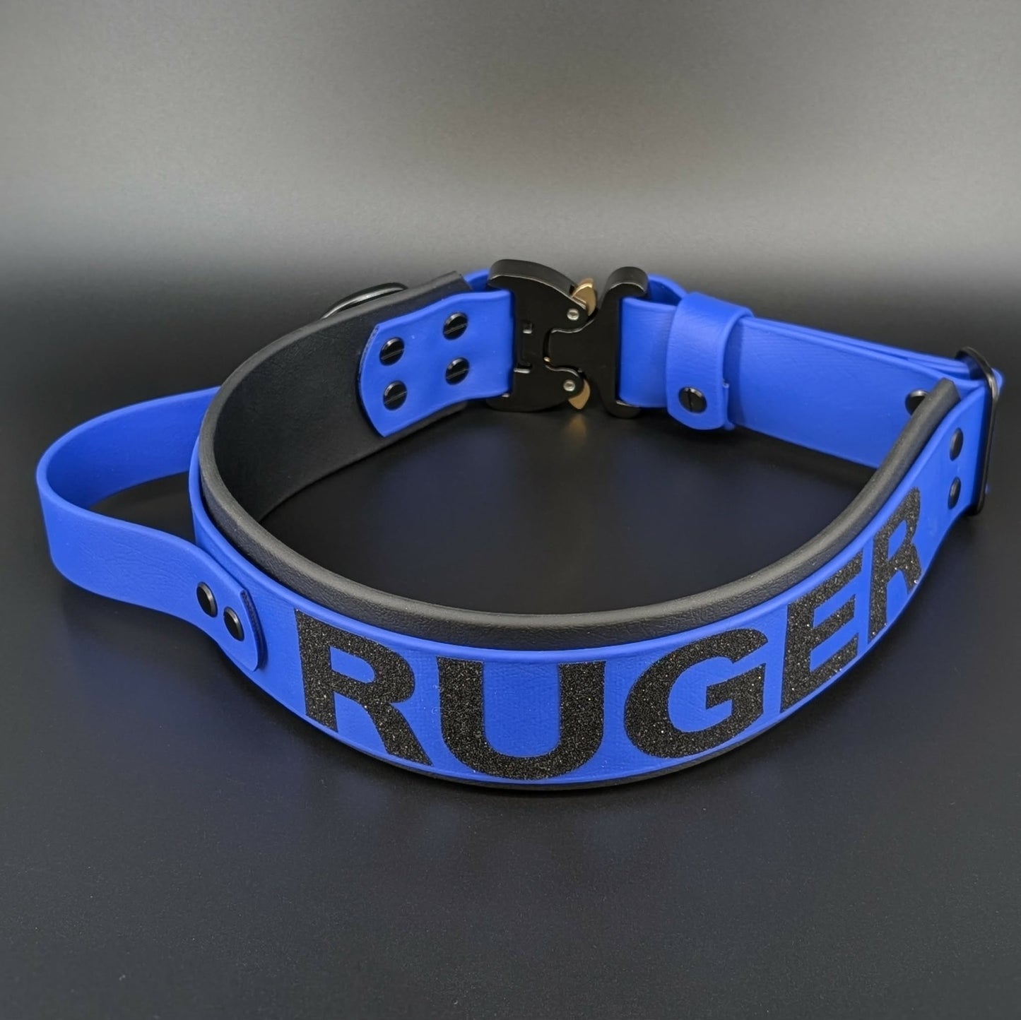 royal blue and black layered biothane dog collar with tactical handle and quick release cobra buckle and custom glitter text