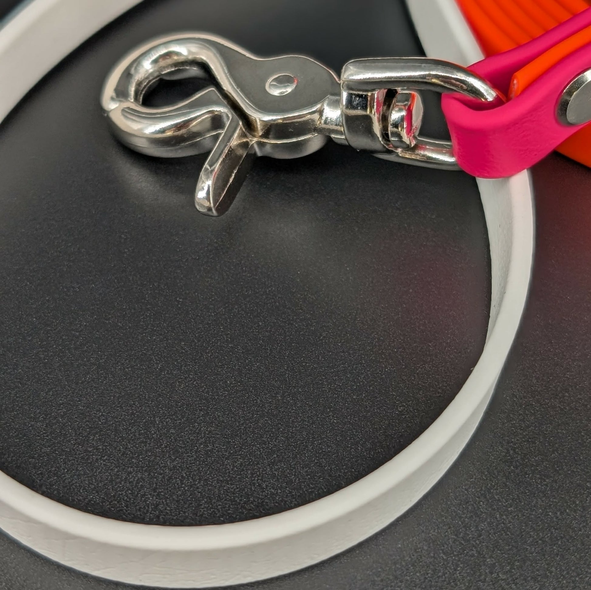 silver trigger snap on orange white and pink biothane leash