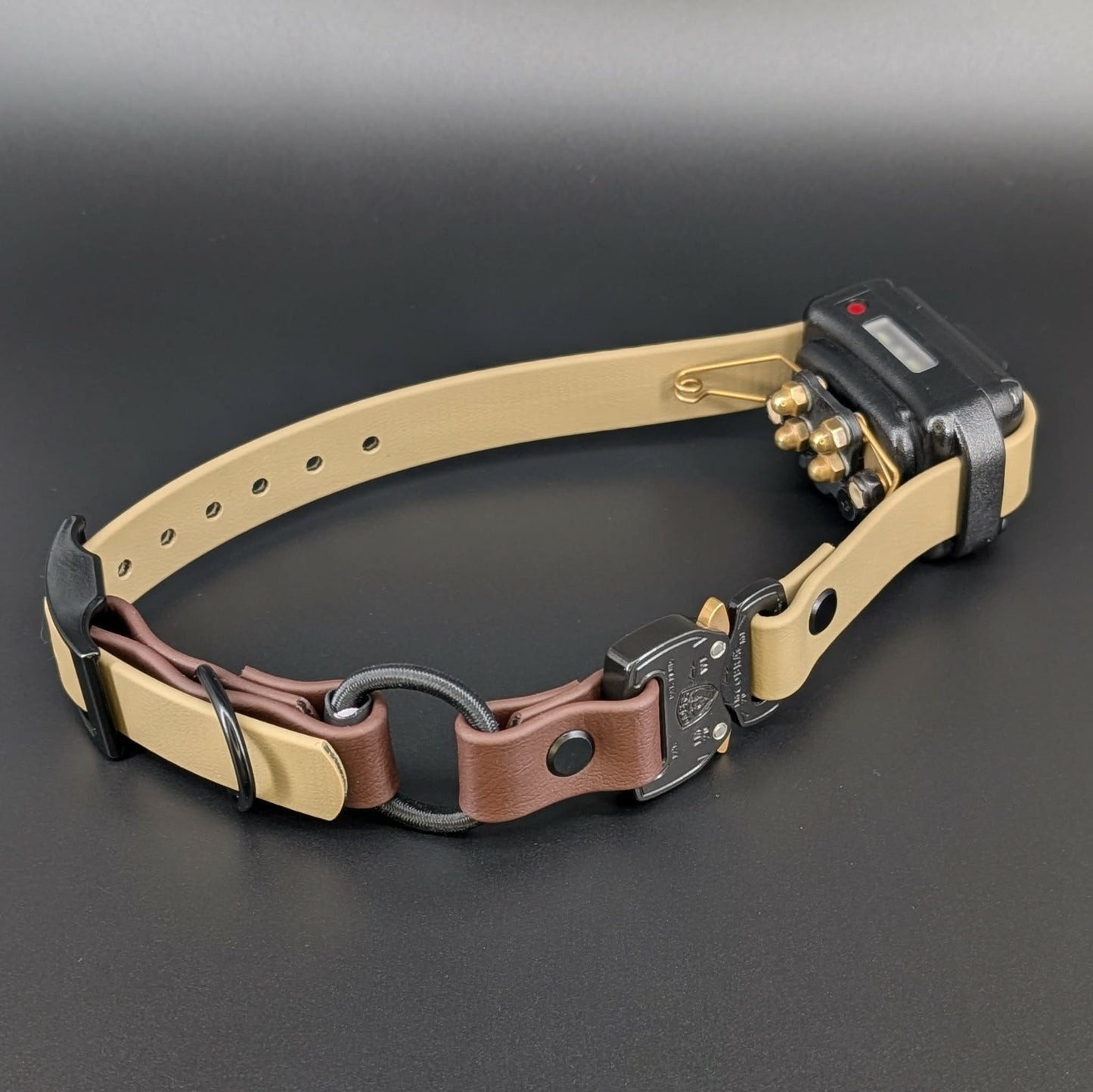 tan and dark brown biothane e-collar strap with bungee and black quick release cobra buckle on a mini educator et-300 with winged contact points for dog training
