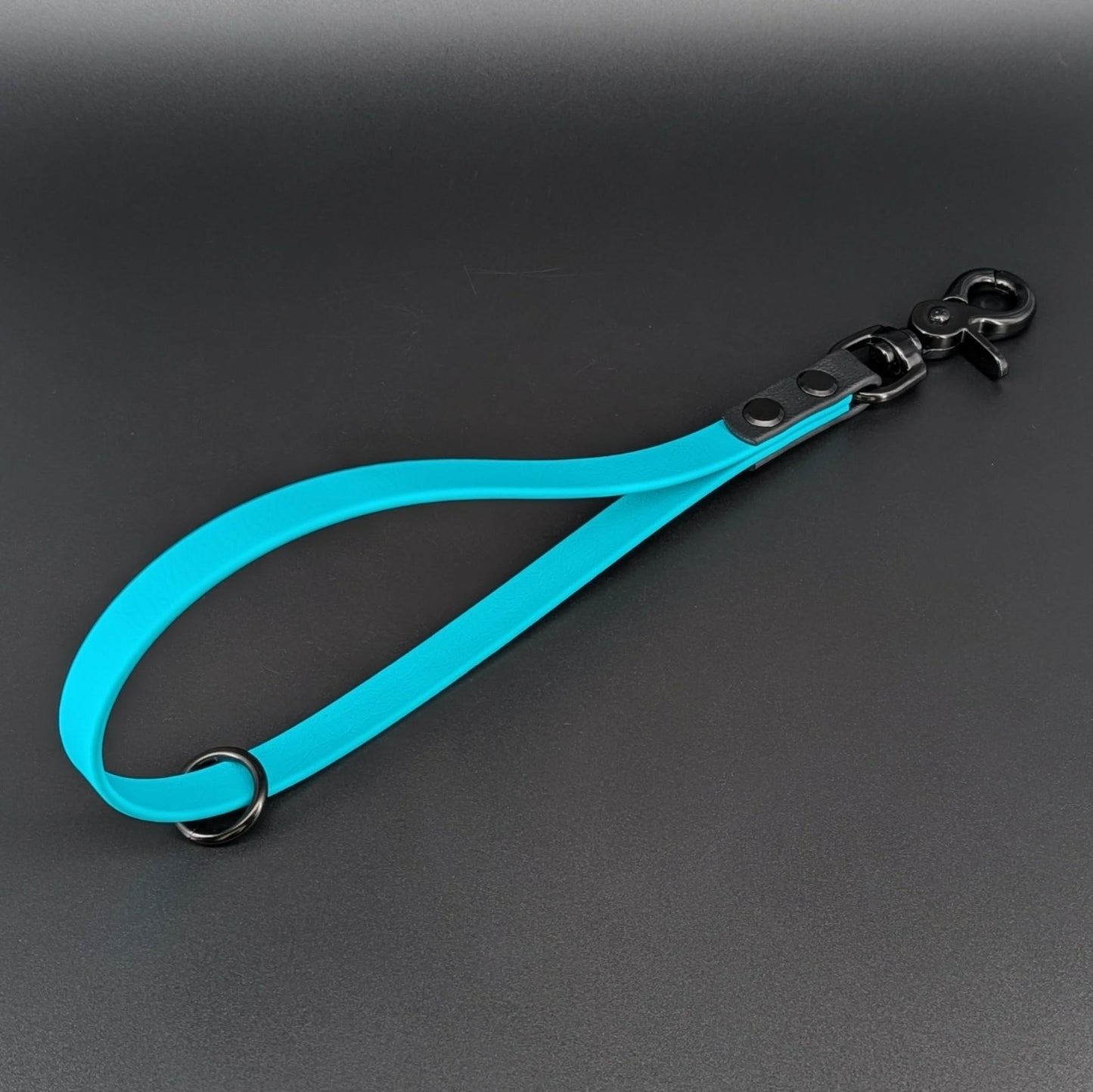 teal and black biothane traffic handle with floating o ring for connecting to longer dog leash