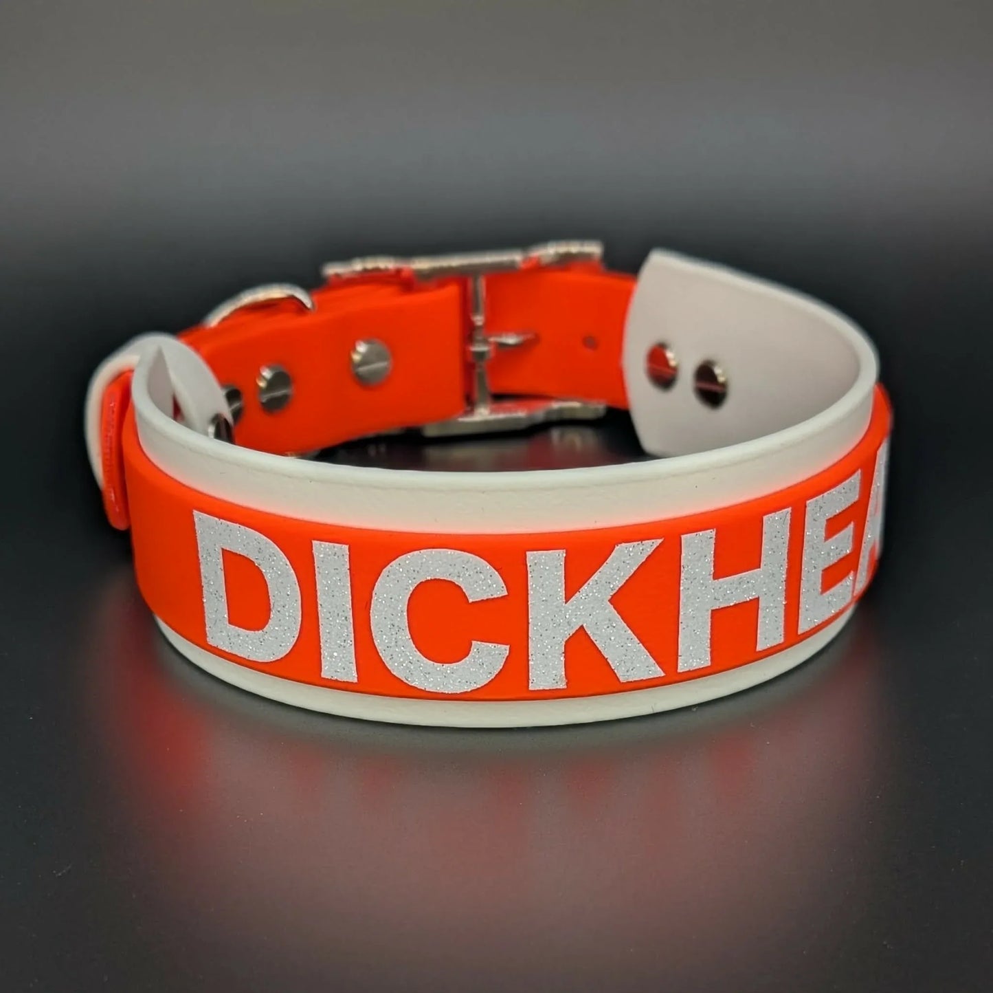 white and orange layered biothane dog collar with dickhead text